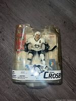 Front view of sealed Sidney Crosby action figure in blister packaging