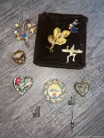 All ten jewelry pieces laid out on surface