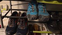 Blue Salomon trail runners and navy/grey Brooks runners on rack