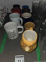 Group of mugs and glass tumblers showing variety and quantity