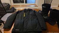 Jacket laid flat and boots standing to show overall condition