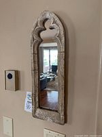Full view of arched wall mirror mounted on wall