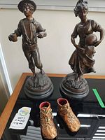 Front view of male and female figurines with boot ornaments