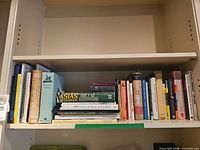 Shelf view showing entire assortment of cookbooks and history titles
