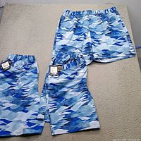 Three blue camo DSG shorts laid out
