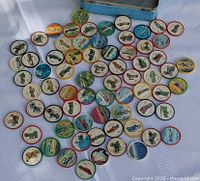 spread of multicoloured plastic vehicle coins on cloth
