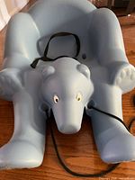 Top view of light blue polar bear shaped sled showing seat, pull rope and eyes detail
