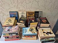 Overall view of three stacks of paperback books on table