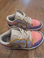 Pair of Nike Air Jordan girls sneakers side view