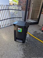 Full view of black plastic step can outdoors