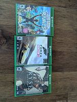 Front view of all three Xbox One game cases
