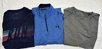 All three tops folded side by side