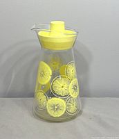 Front view of Pyrex carafe showing lemon graphics and lid
