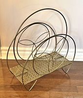 Front view of gold-tone circular wire magazine rack