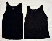 Both black tank tops laid flat front view