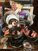 Wide view of assorted kitchen baking pans, including Christmas tree shaped pans, many round tart pans, and Bundt pans.