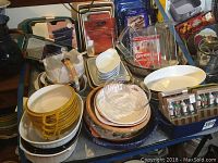 Wide view of various baking dishes in glass and ceramic, showing an assortment of round and rectangular dishes and some boxed figurines