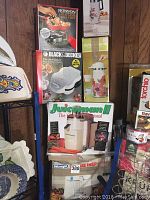 Black & Decker Shellbaker, Juiceman II juicer in box, Ronson barbeque basket, and floral patterned thermal carafe
