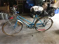 Side view of blue Ross Euro Tour bicycle with front basket showing overall condition and setup.