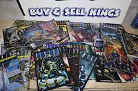 Spread of entire lot of Aliens and AvP comics on table