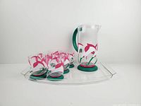 Pitcher, six tumblers and serving tray displayed