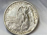 Reverse of 1925 Stone Mountain half dollar showing eagle, legends, wear