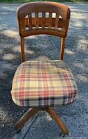 Front view showing wood slat back and plaid upholstered seat