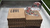 Stack of kraft boxes with acrylic heart plaque on top