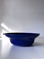 Side profile of cobalt blue bowl showing shape and black rim