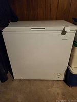 Front view of closed white Frigidaire chest freezer