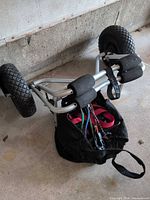WheelEEZ kayak cart showing frame, wheels, foam pads, bag with tie-down straps