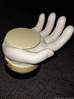 Front view of plastic hand drink server on base
