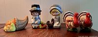 Full lot showing cornucopia shakers, pilgrim figurines, turkey candle holders