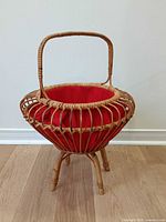 Full view standing bamboo knitting basket on tripod legs