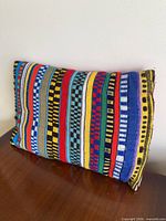 Front view of multicolor striped pillow on table