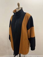 Front view of Niccolini black and camel wool-blend coat on dress form