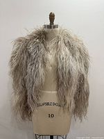 Front view of feather jacket on size-10 dress form