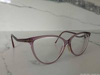 Angled front-left view of lilac Tom Ford cat eye eyeglasses showing frame shape and color