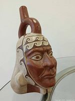 Front view of Moche pottery head jug