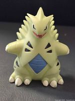 Front view of Bandai Tyranitar finger puppet showing color and design