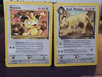Front view of Meowth and Dark Persian cards side by side