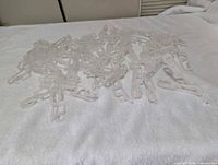 Pile of clear plastic light clips spread on white surface