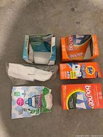 Group shot of all packages on floor showing brands and quantities