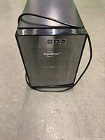 Front view of Koolatron mini wine cooler showing glass door and power cord