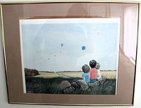 Framed print showing children with balloons, matting and gold frame visible