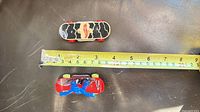 Top view of two fingerboards with tape measure indicating length (~7 cm)
