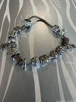 Full view of bracelet on background showing clasp and charms
