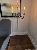 Full view of floor candelabra staged with candles to show scale and overall design
