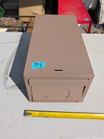 Top view of tan metal file box with tape measure showing length