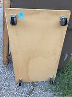 Top view of dolly showing two swivel casters and stain marks